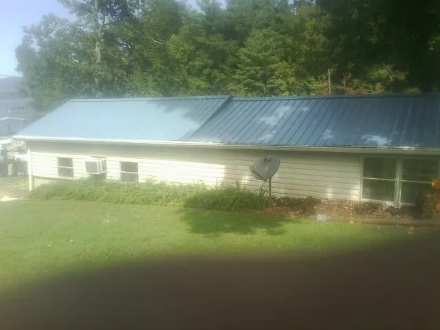 Blue metal roof running the length of a single story home in New Riegel